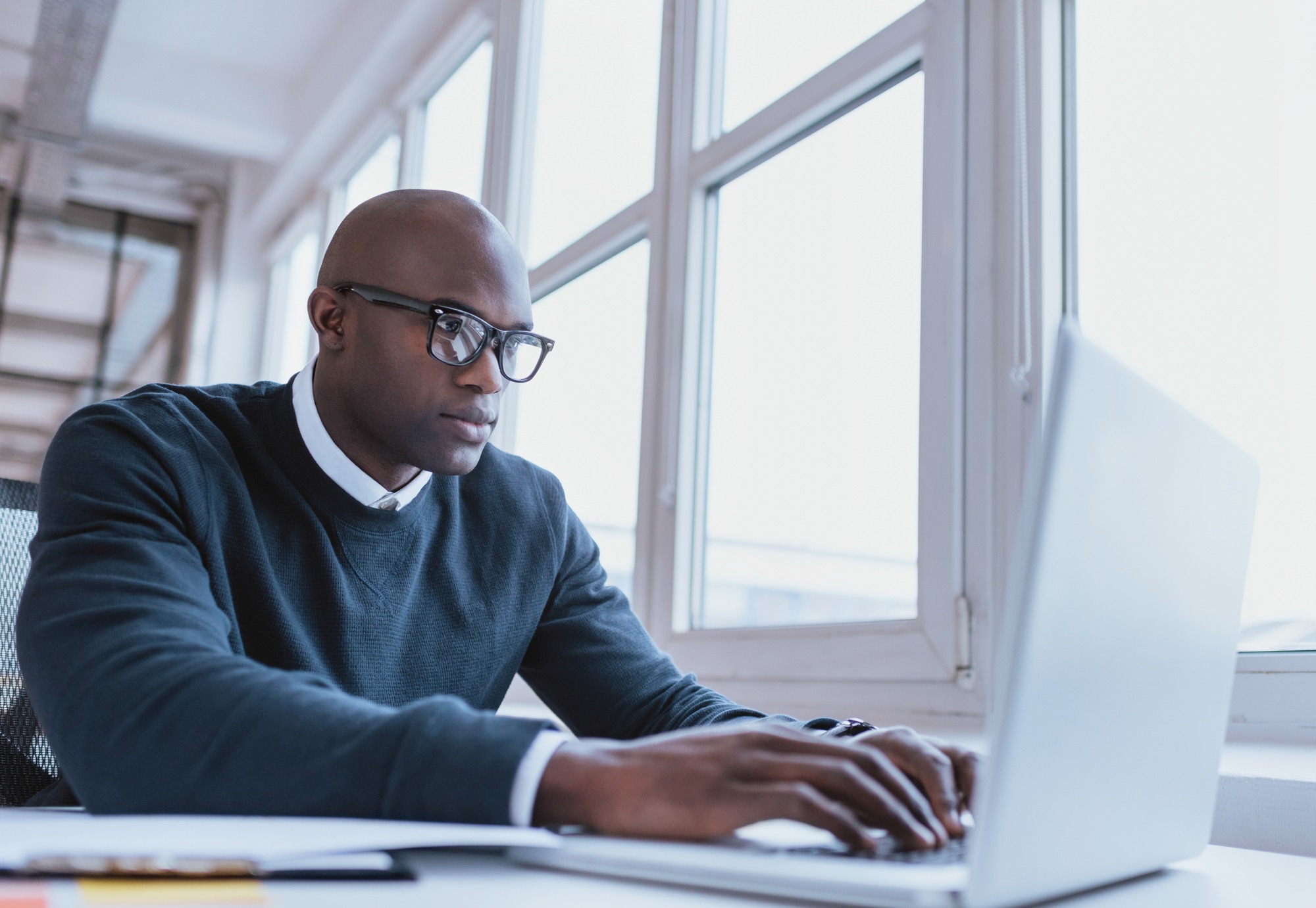 Image of african american searching for job post online.